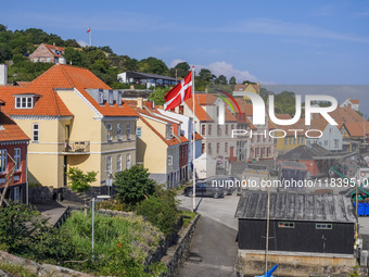 A general view of the city and port with the Danish flag in the wind is seen in Gudhjem, Bornholm Island, Denmark, on August 6, 2024. (