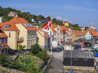 A general view of the city and port with the Danish flag in the wind is seen in Gudhjem, Bornholm Island, Denmark, on August 6, 2024. (