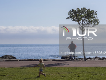 A man looks at the sea on the Baltic Sea coast in Gudhjem, Bornholm Island, Denmark, on August 6, 2024. (