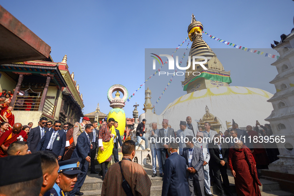 Bhutanese King Jigme Khesar Namgyel Wangchuk (wearing a yellow robe) tours around Swayambhunath Stupa, a UNESCO World Heritage Site, during...