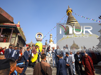 Bhutanese King Jigme Khesar Namgyel Wangchuk (wearing a yellow robe) tours around Swayambhunath Stupa, a UNESCO World Heritage Site, during...