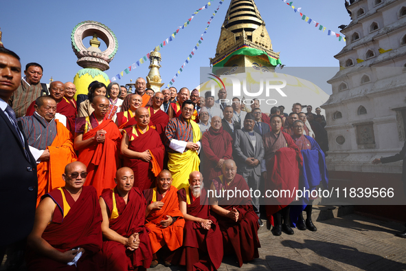 Bhutanese King Jigme Khesar Namgyel Wangchuk (wearing a yellow robe) poses for a photo with the monks against the backdrop of Swayambhunath...