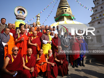 Bhutanese King Jigme Khesar Namgyel Wangchuk (wearing a yellow robe) poses for a photo with the monks against the backdrop of Swayambhunath...