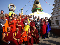 Bhutanese King Jigme Khesar Namgyel Wangchuk (wearing a yellow robe) poses for a photo with the monks against the backdrop of Swayambhunath...