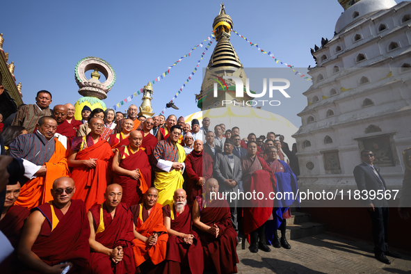 Bhutanese King Jigme Khesar Namgyel Wangchuk (wearing a yellow robe) poses for a photo with the monks against the backdrop of Swayambhunath...