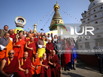 Bhutanese King Jigme Khesar Namgyel Wangchuk (wearing a yellow robe) poses for a photo with the monks against the backdrop of Swayambhunath...