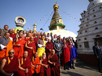 Bhutanese King Jigme Khesar Namgyel Wangchuk (wearing a yellow robe) poses for a photo with the monks against the backdrop of Swayambhunath...