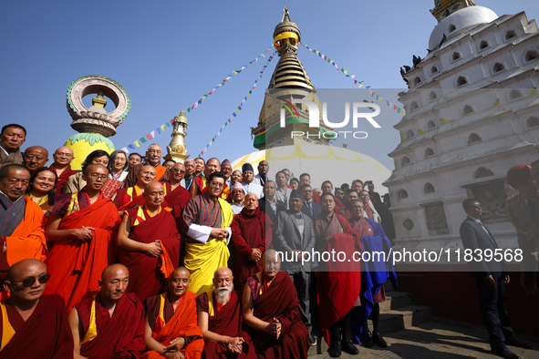 Bhutanese King Jigme Khesar Namgyel Wangchuk (wearing a yellow robe) poses for a photo with the monks against the backdrop of Swayambhunath...