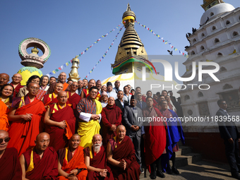 Bhutanese King Jigme Khesar Namgyel Wangchuk (wearing a yellow robe) poses for a photo with the monks against the backdrop of Swayambhunath...