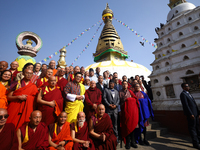 Bhutanese King Jigme Khesar Namgyel Wangchuk (wearing a yellow robe) poses for a photo with the monks against the backdrop of Swayambhunath...