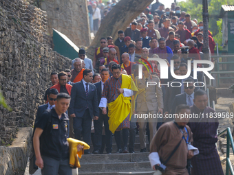 Bhutanese King Jigme Khesar Namgyel Wangchuk (wearing a yellow robe) tours around Swayambhunath Stupa, a UNESCO World Heritage Site, during...