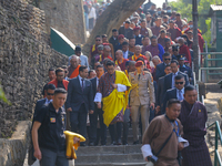 Bhutanese King Jigme Khesar Namgyel Wangchuk (wearing a yellow robe) tours around Swayambhunath Stupa, a UNESCO World Heritage Site, during...