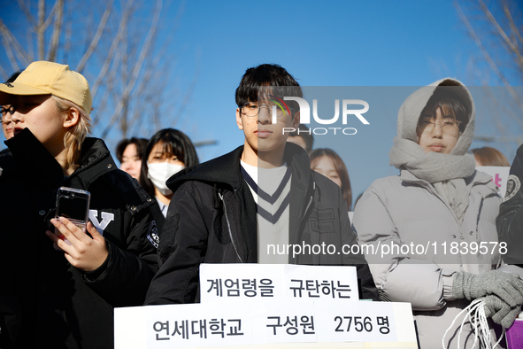 A group of dozens of current students and alumni from Yonsei University holds a press conference condemning President Yoon Suk-yeol's martia...