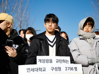 A group of dozens of current students and alumni from Yonsei University holds a press conference condemning President Yoon Suk-yeol's martia...