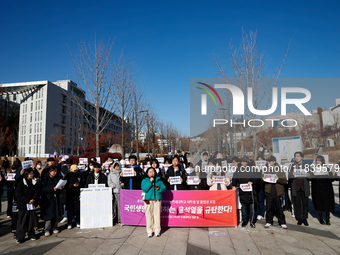 A group of dozens of current students and alumni from Yonsei University holds a press conference condemning President Yoon Suk-yeol's martia...