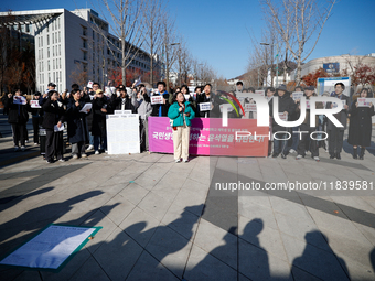 A group of dozens of current students and alumni from Yonsei University holds a press conference condemning President Yoon Suk-yeol's martia...