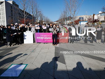 A group of dozens of current students and alumni from Yonsei University holds a press conference condemning President Yoon Suk-yeol's martia...