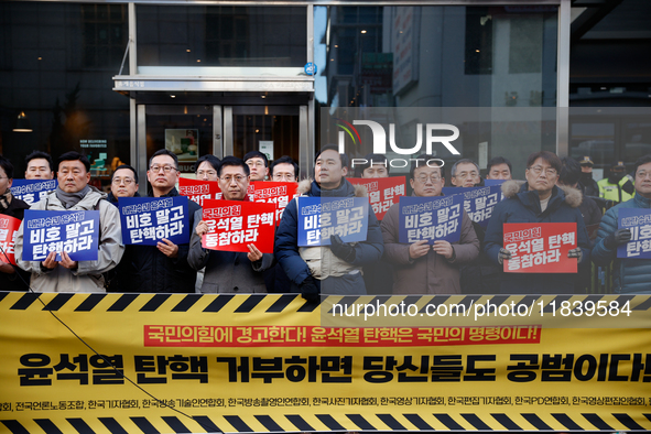 A coalition of 11 media organizations, including the National Union of Media Workers, holds a press conference in front of the People Power...