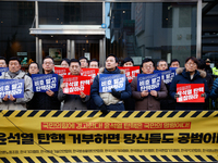 A coalition of 11 media organizations, including the National Union of Media Workers, holds a press conference in front of the People Power...