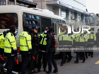 Police set up barricades in front of the People Power Party headquarters, the site of a rally by 11 media organizations, including the Natio...