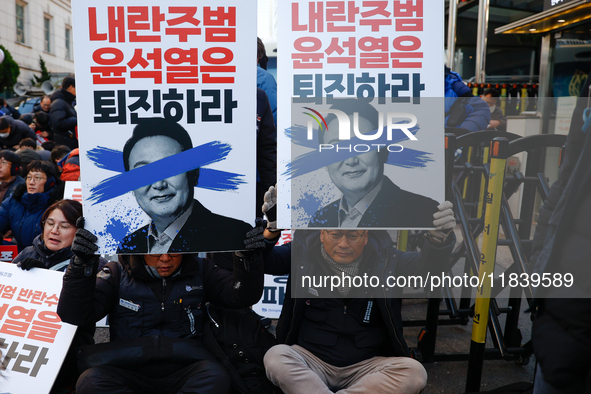 Over a hundred participants hold placards and chant slogans during the Immediate Impeachment of Traitor Yoon Suk-yeol Condemn the People Pow...