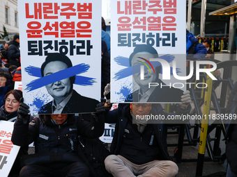 Over a hundred participants hold placards and chant slogans during the Immediate Impeachment of Traitor Yoon Suk-yeol Condemn the People Pow...