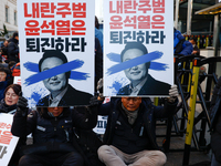 Over a hundred participants hold placards and chant slogans during the Immediate Impeachment of Traitor Yoon Suk-yeol Condemn the People Pow...