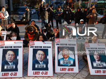 Over a hundred participants hold placards and chant slogans during the Immediate Impeachment of Traitor Yoon Suk-yeol Condemn the People Pow...