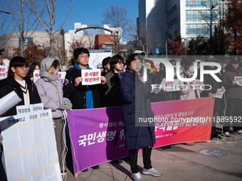 A group of dozens of current students and alumni from Yonsei University holds a press conference condemning President Yoon Suk-yeol's martia...