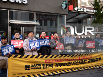 A coalition of 11 media organizations, including the National Union of Media Workers, holds a press conference in front of the People Power...