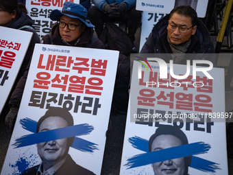 Over a hundred participants hold placards and chant slogans during the Immediate Impeachment of Traitor Yoon Suk-yeol Condemn the People Pow...