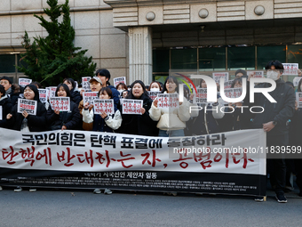 University students hold a protest in front of the People's Power Party headquarters in Seoul, South Korea, on December 6, 2024, condemning...