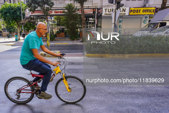 A man on a bicycle cycles in Alanya, Turkey, on November 3, 2024. 