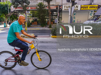 A man on a bicycle cycles in Alanya, Turkey, on November 3, 2024. (