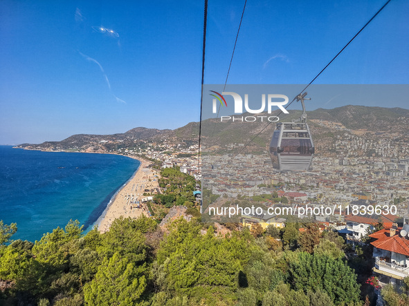 A cable car of the mountain railway with a city view in the background is seen in Alanya, Turkey, on November 5, 2024. 