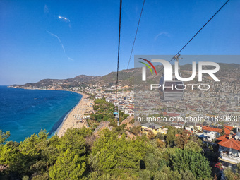 A cable car of the mountain railway with a city view in the background is seen in Alanya, Turkey, on November 5, 2024. (