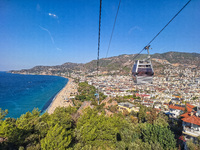 A cable car of the mountain railway with a city view in the background is seen in Alanya, Turkey, on November 5, 2024. (