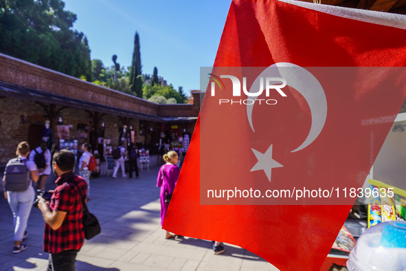 People visit a local market in Alanya, Turkey, on November 5, 2024. The Turkish flag is visible. 