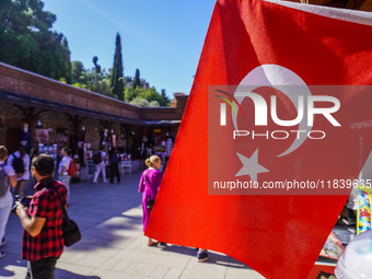 People visit a local market in Alanya, Turkey, on November 5, 2024. The Turkish flag is visible. (