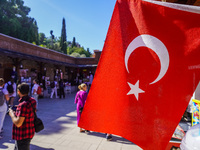 People visit a local market in Alanya, Turkey, on November 5, 2024. The Turkish flag is visible. (