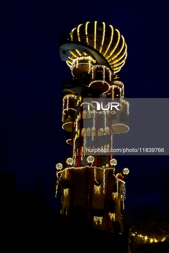 The Kuchlbauer Tower, designed by Friedensreich Hundertwasser, is illuminated for Christmas. In the historic center of Abensberg, Bavaria, G...