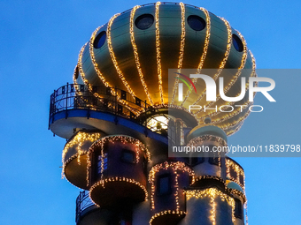 The Kuchlbauer Tower, designed by Friedensreich Hundertwasser, is illuminated for Christmas. In the historic center of Abensberg, Bavaria, G...