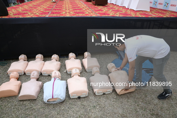 A medical official arranges mannequins before demonstrating lifesaving Cardiopulmonary Resuscitation (CPR) on a mannequin with breathing pro...