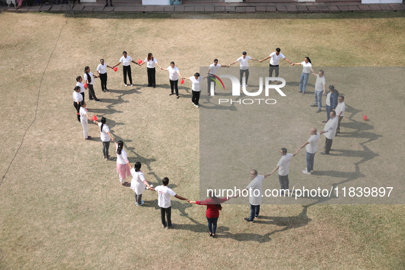 Medical officials form a heart shape before they demonstrate lifesaving Cardiopulmonary Resuscitation (CPR) on a mannequin with breathing pr...