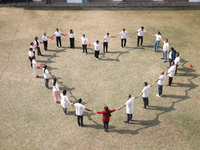 Medical officials form a heart shape before they demonstrate lifesaving Cardiopulmonary Resuscitation (CPR) on a mannequin with breathing pr...