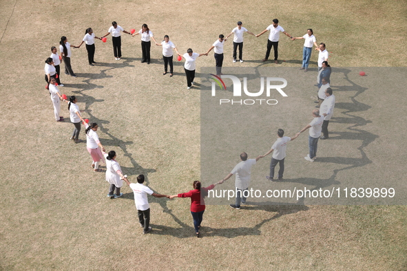 Medical officials form a heart shape before they demonstrate lifesaving Cardiopulmonary Resuscitation (CPR) on a mannequin with breathing pr...