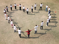 Medical officials form a heart shape before they demonstrate lifesaving Cardiopulmonary Resuscitation (CPR) on a mannequin with breathing pr...