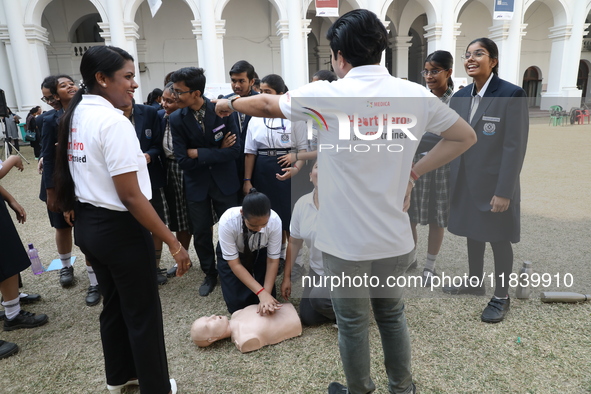 A medical official demonstrates lifesaving Cardiopulmonary Resuscitation (CPR) on a mannequin with breathing problems during a CPR training...