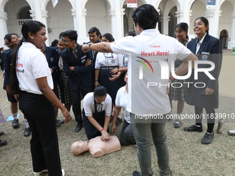 A medical official demonstrates lifesaving Cardiopulmonary Resuscitation (CPR) on a mannequin with breathing problems during a CPR training...