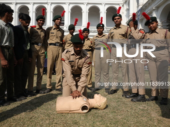 A medical official demonstrates lifesaving Cardiopulmonary Resuscitation (CPR) on a mannequin with breathing problems during a CPR training...